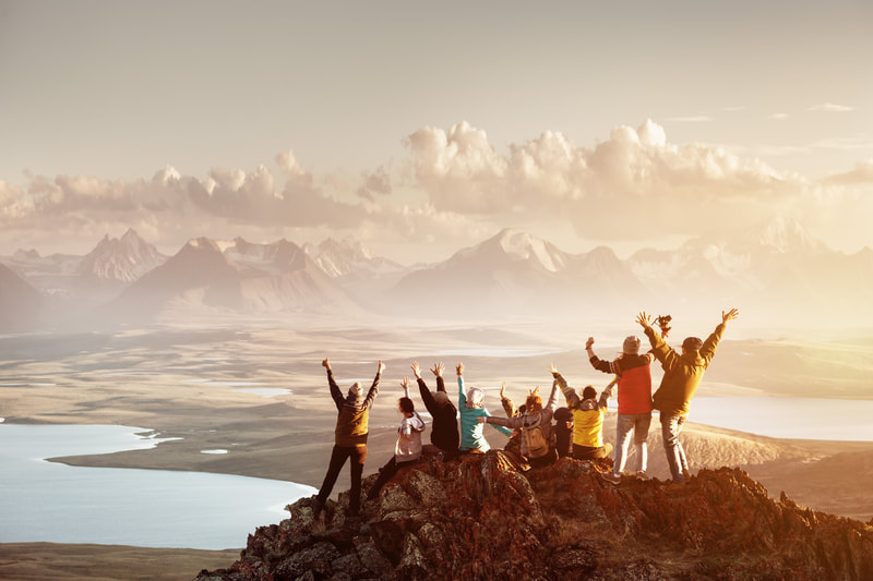 Group of tourist at the top of a mountain. 
