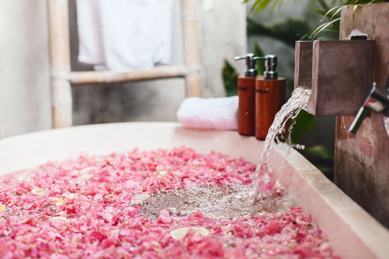 Romantic tub full of petals at a luxury resort. 